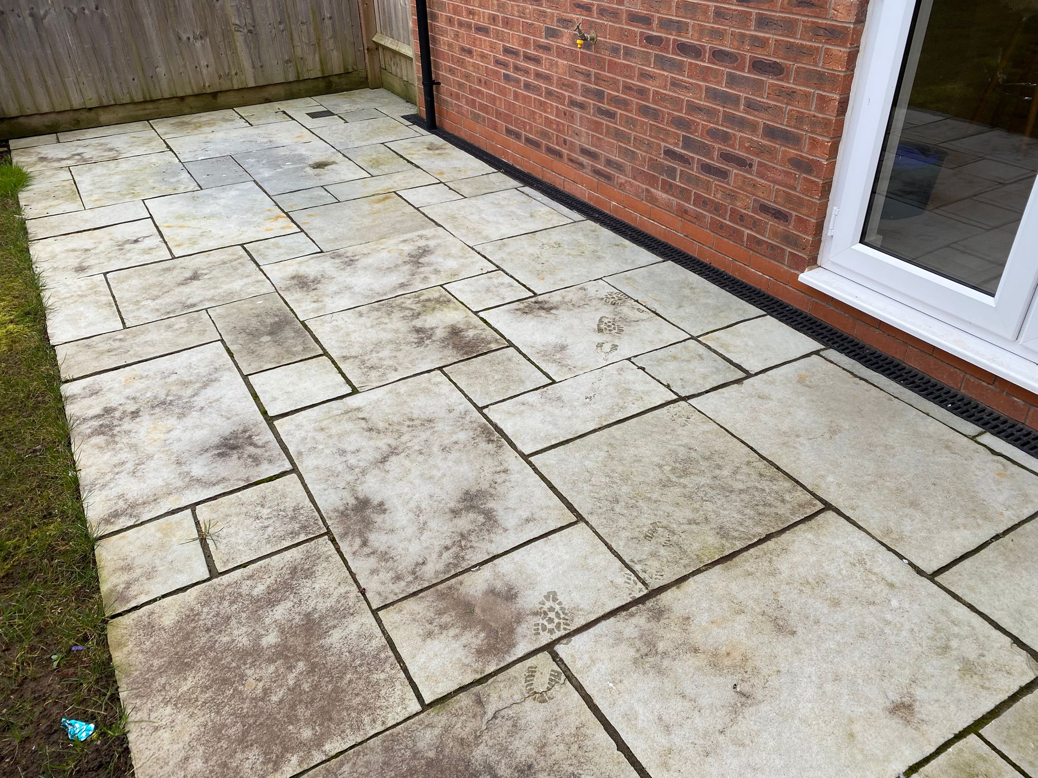 Natural stone patio cleared of moss, stains and footprints – before cleaning