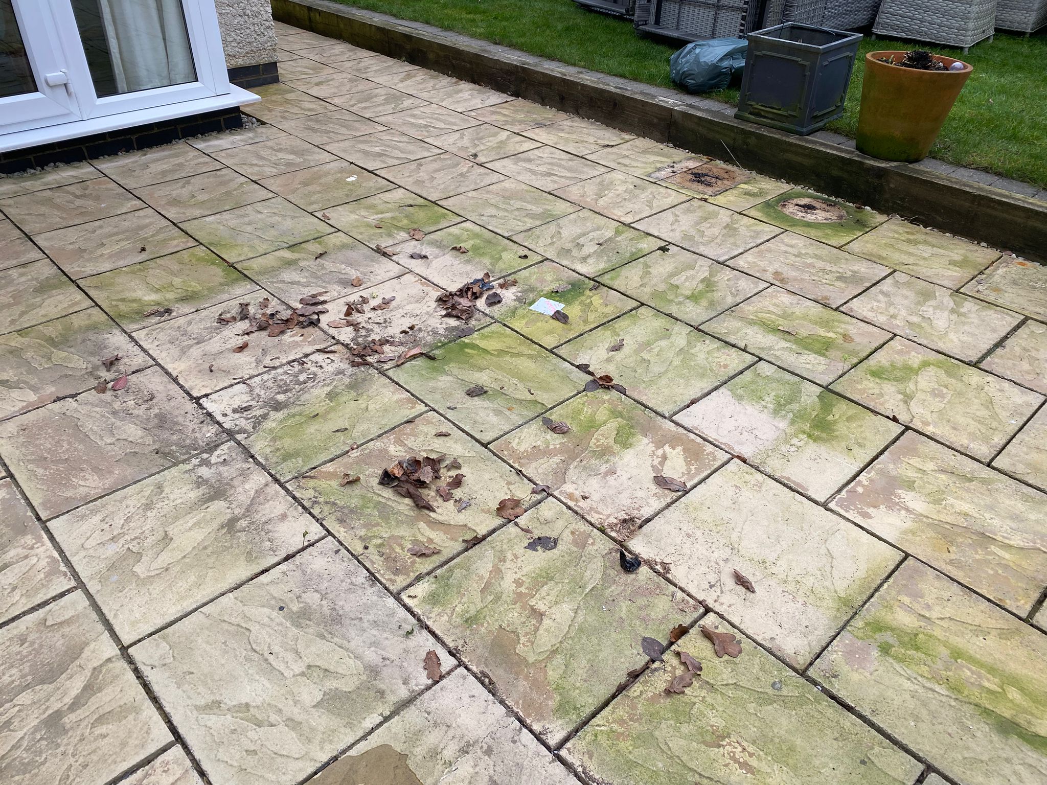 Garden patio deep cleaned — algae, leaves and grime removed – before cleaning